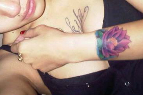 Pink Ink Lotus Flower Tattoo On Girl Left Wrist