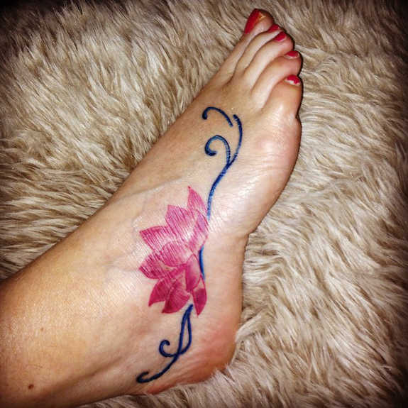 Pink Ink Lotus Flower Tattoo On Girl Right Foot