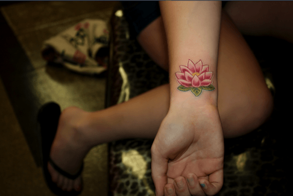 Pink Ink Lotus Flower Tattoo On Right Wrist