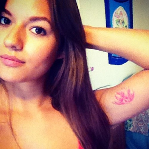 Pink Ink Small Lotus Flower Tattoo On Girl Left Bicep