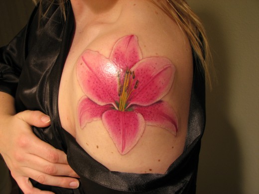 Pink Lily Flower Tattoo On Girl Left Shoulder