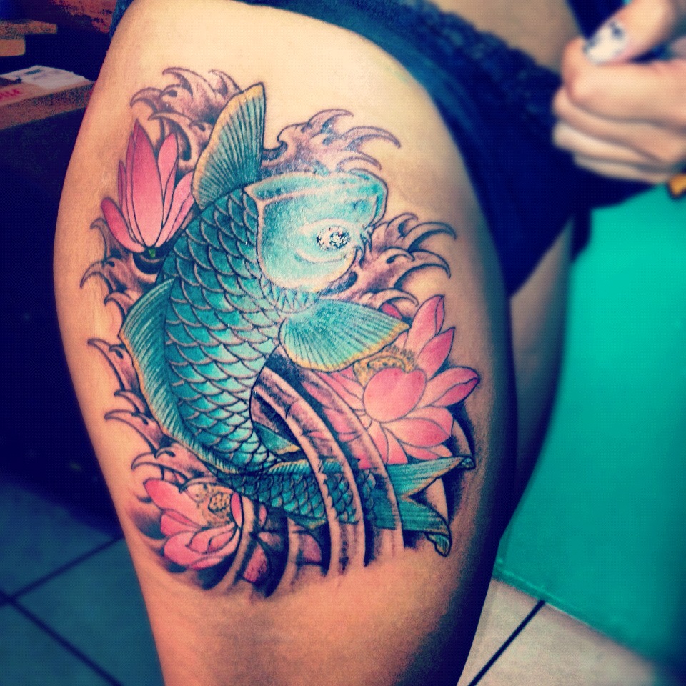 Pink Lotus Flowers With Blue Koi Fish Tattoo On Girl Right Thigh
