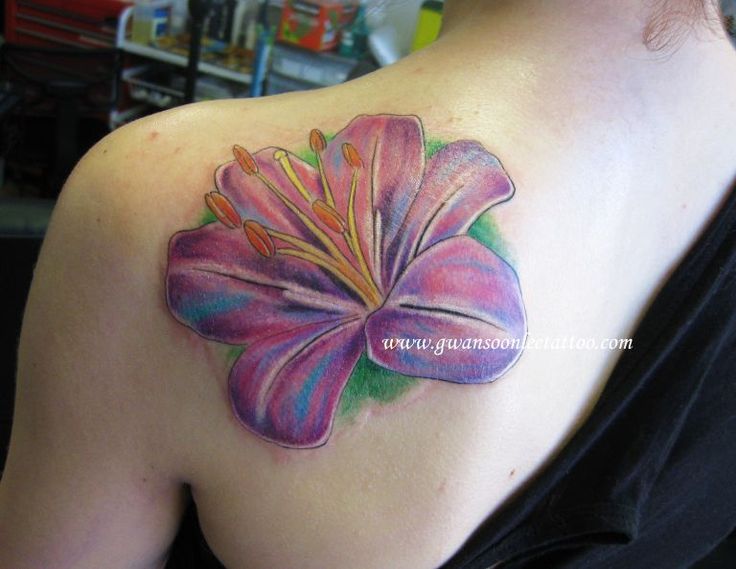 Purple Ink Lily Flower Tattoo On Girl Left Back Shoulder