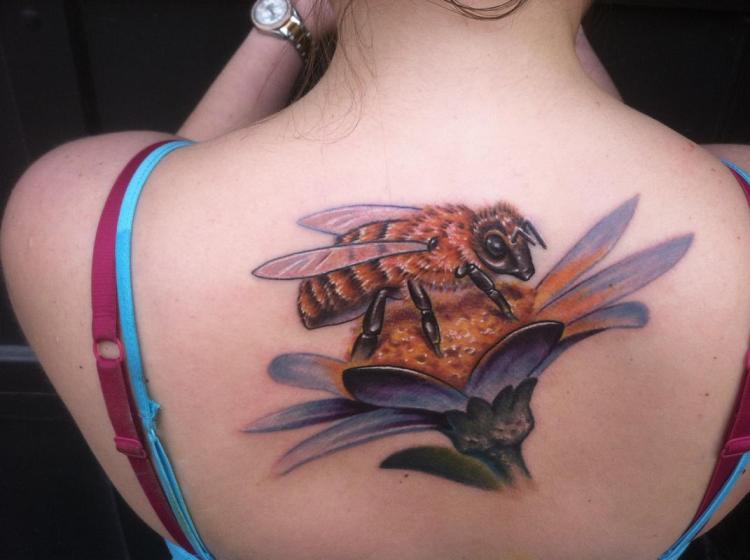 Realistic Bamblebee On Flowers Tattoo On Girl Upper Back