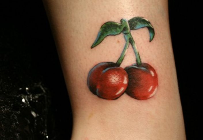 Red Ink Cherry Tattoo On Bicep