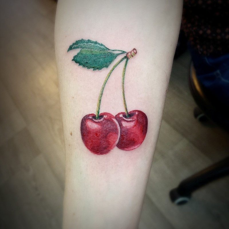 Red ink Cherry Tattoo On Forearm