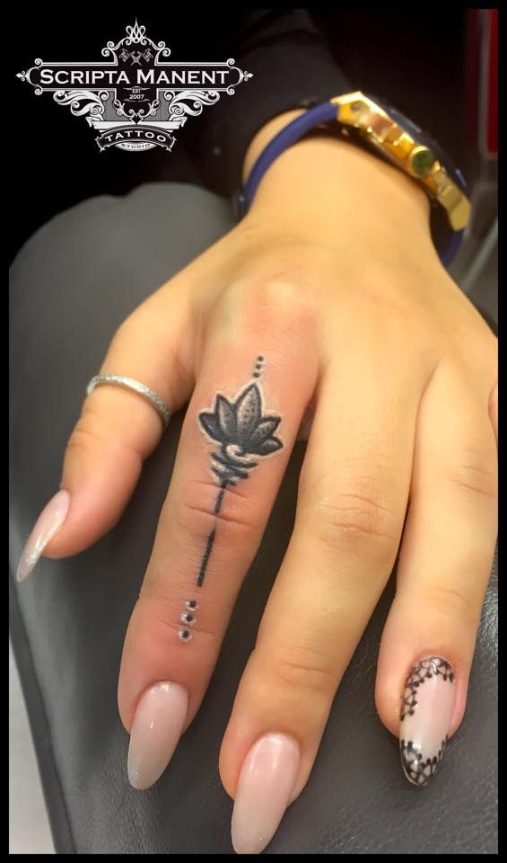Simple Black And Grey Lotus Tattoo On Girl Left Finger