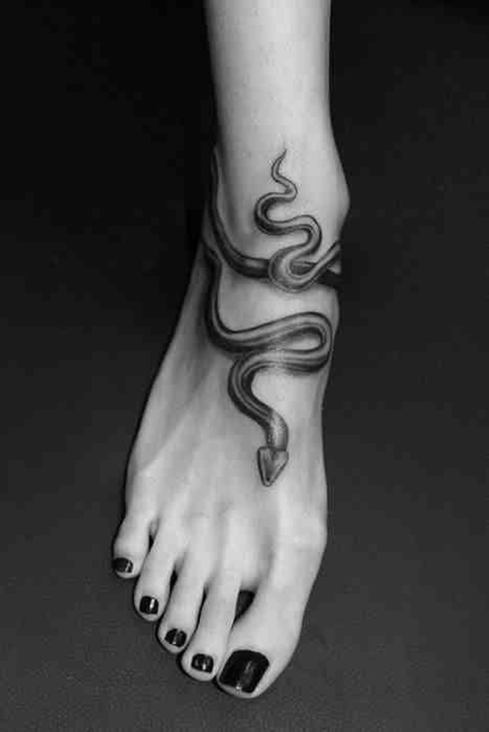 Simple Black Ink Snake Tattoo On Women Right Foot