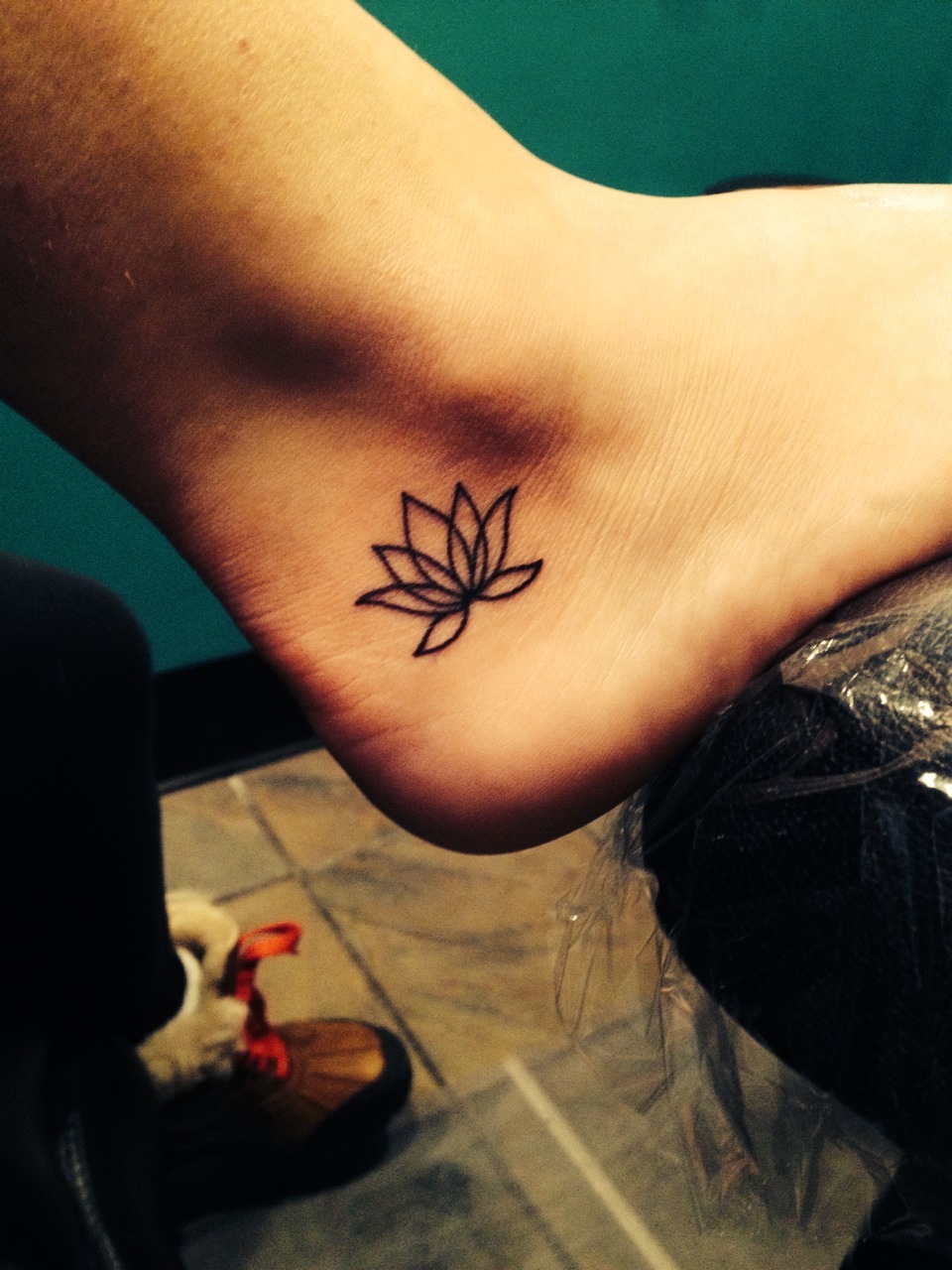 Simple Black Outline Lotus Flower Tattoo On Right Ankle