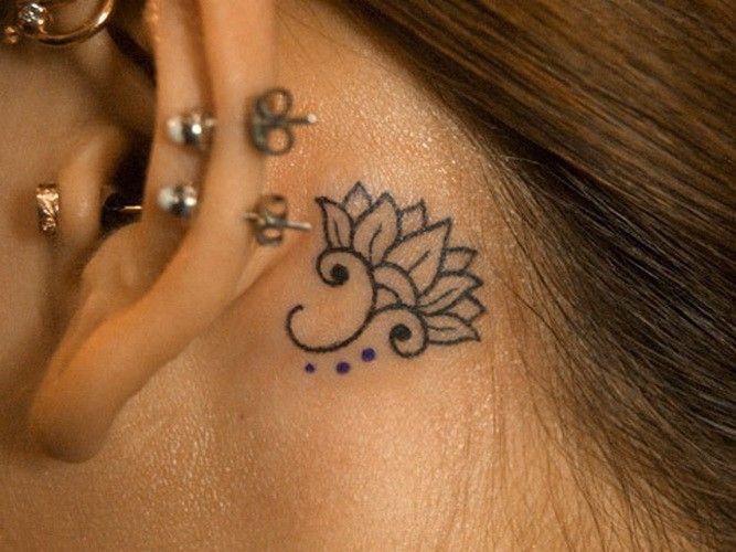 Simple Black Outline Lotus Tattoo On Girl Left Behind The Ear