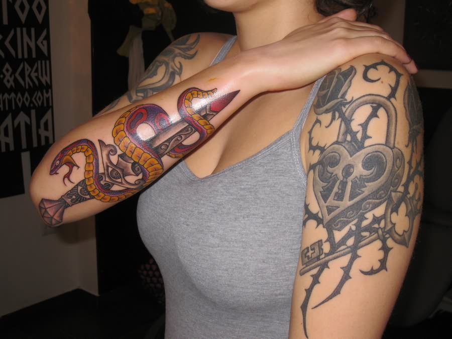 Snake With Dagger Tattoo On Women Right Arm