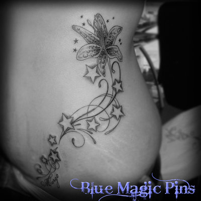 Stars And Lily Tattoo On Girl Hip