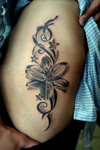 Stars Tribal And Black And Grey Lily Tattoo On Side Rib