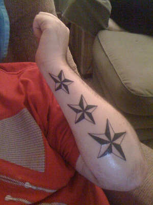 Three Nautical Star Tattoos On Left Arm