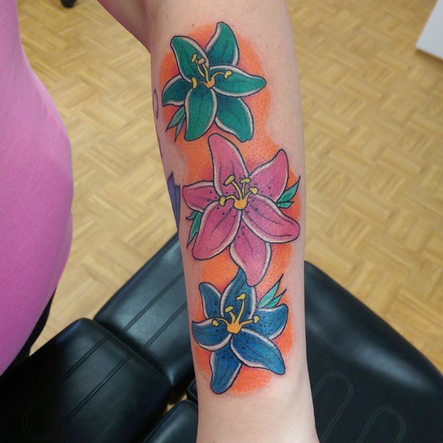 Three Watercolor Lily Flowers Tattoos On Forearm