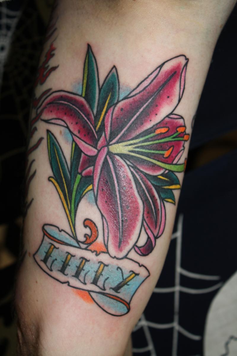 Traditional Lily Flower With Banner Tattoo Design For Upper Arm