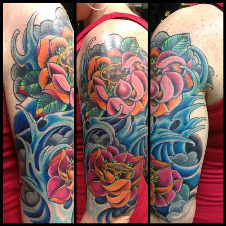 Traditional Lotus Flowers In Water Tattoo On Girl Left Half Sleeve
