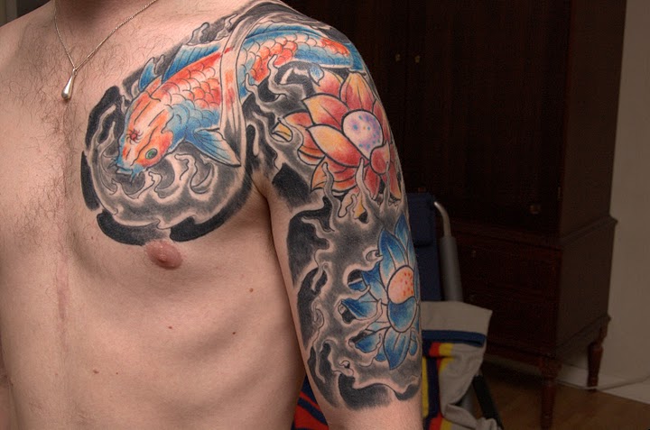 Traditional Lotus Flowers With Koi Fish Tattoo On Man Left Shoulder And Half Sleeve By Lars Erik