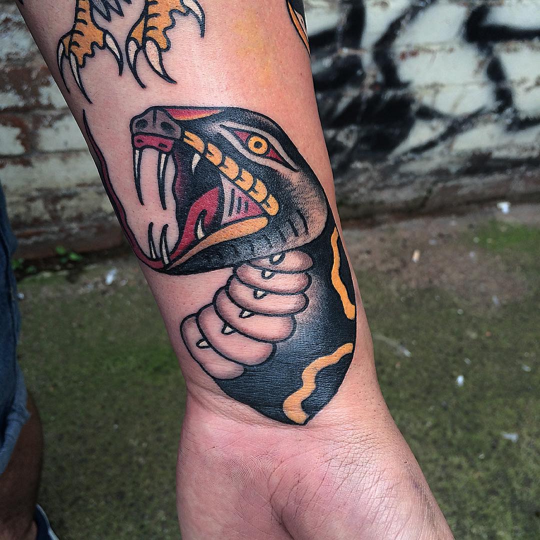 Traditional Snake Head Tattoo On Left Wrist
