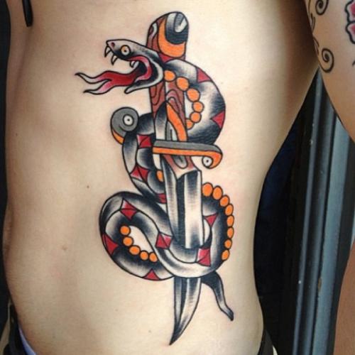 Traditional Snake With Dagger Tattoo On Man Left Side Rib