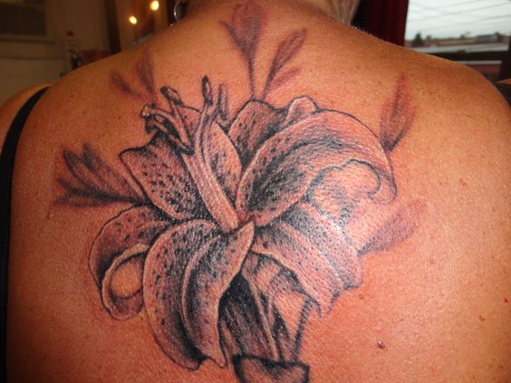Upper Back Grey Ink Lily Tattoo For Girls