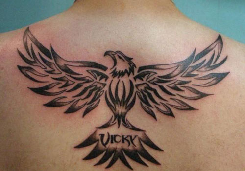 Vicky – Black Tribal Flying Eagle Tattoo On Man Upper Back