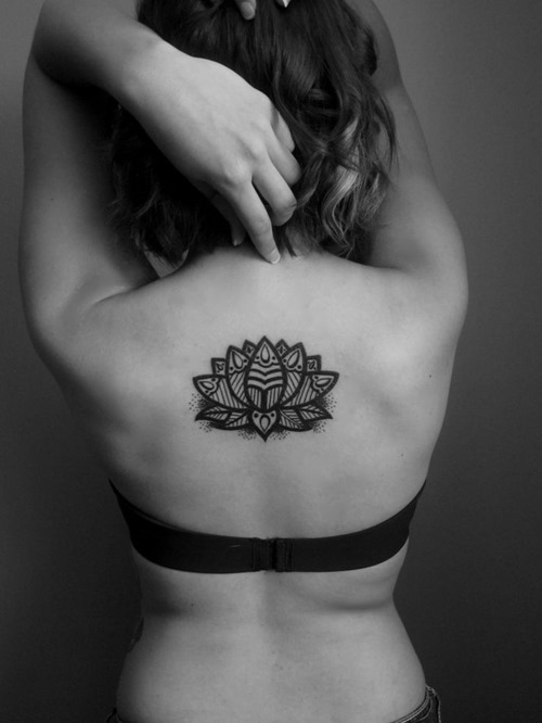 Wonderful Black Ink Lotus Flower Tattoo On Girl Upper Back
