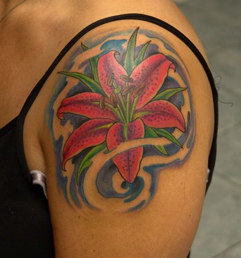 Wonderful Lily Flower Tattoo On Girl Left Shoulder