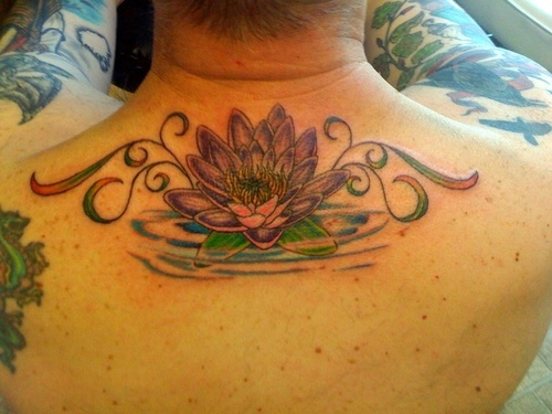 Wonderful Lotus Flower In Water Tattoo On Man Upper Back