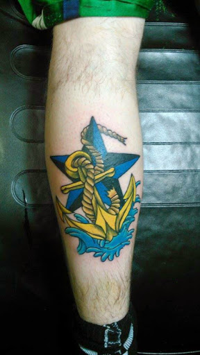 Yellow Anchor And Nautical Star Tattoo On Leg