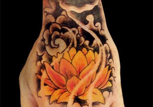 Yellow Ink Lotus Flower Tattoo On Left Hand