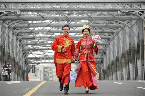 A Couple Dressed In Traditional Chinese Costumes Dart Across Waibaidu Bridge