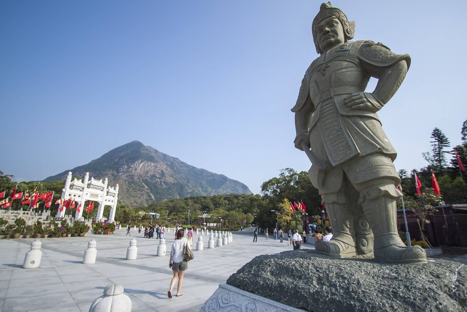 A Statue Guarding The Avenue Leading Towards The Tian Tan Buddha