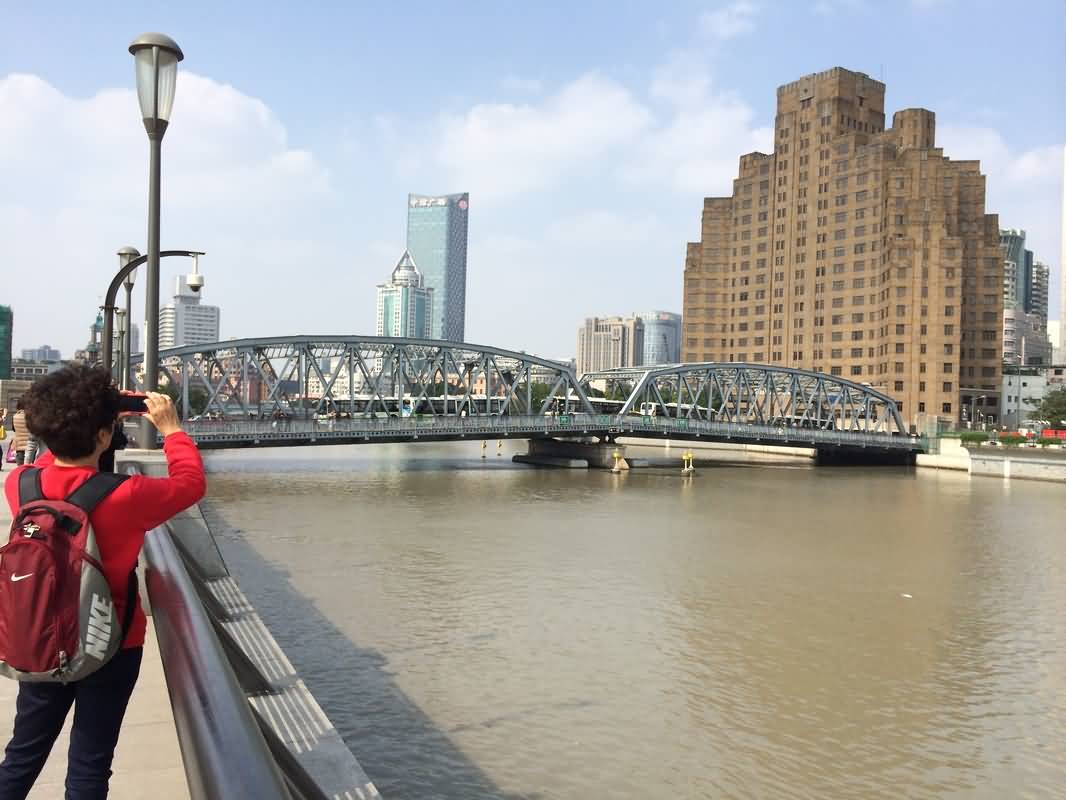 A Tourist Takes Photograph Of Waibaidu Bridge
