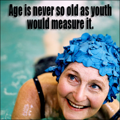 Elderly woman swimming in swimming pool wearing a swimming cap