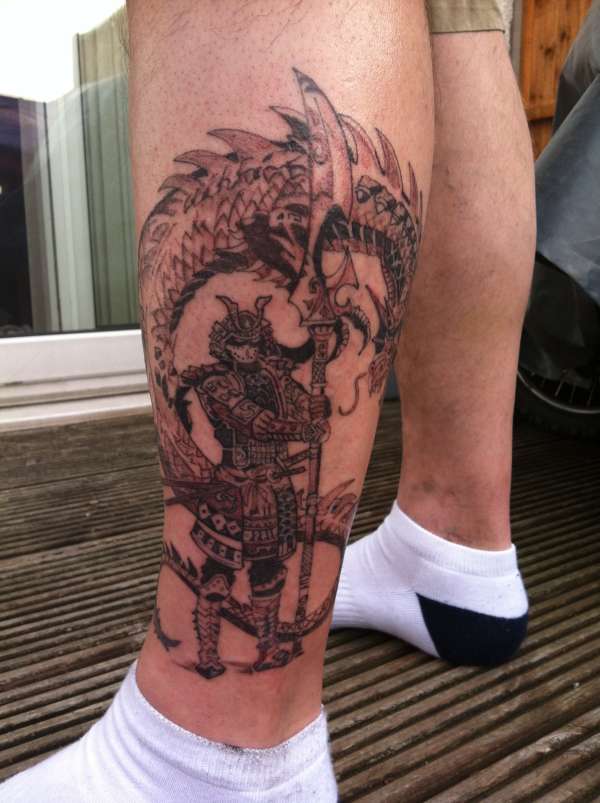 Attractive Black Ink Samurai With Dragon Tattoo On Left Leg