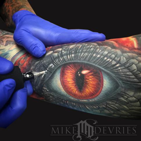 Attractive Reptile Eye Tattoo On Bicep By Mike Devries