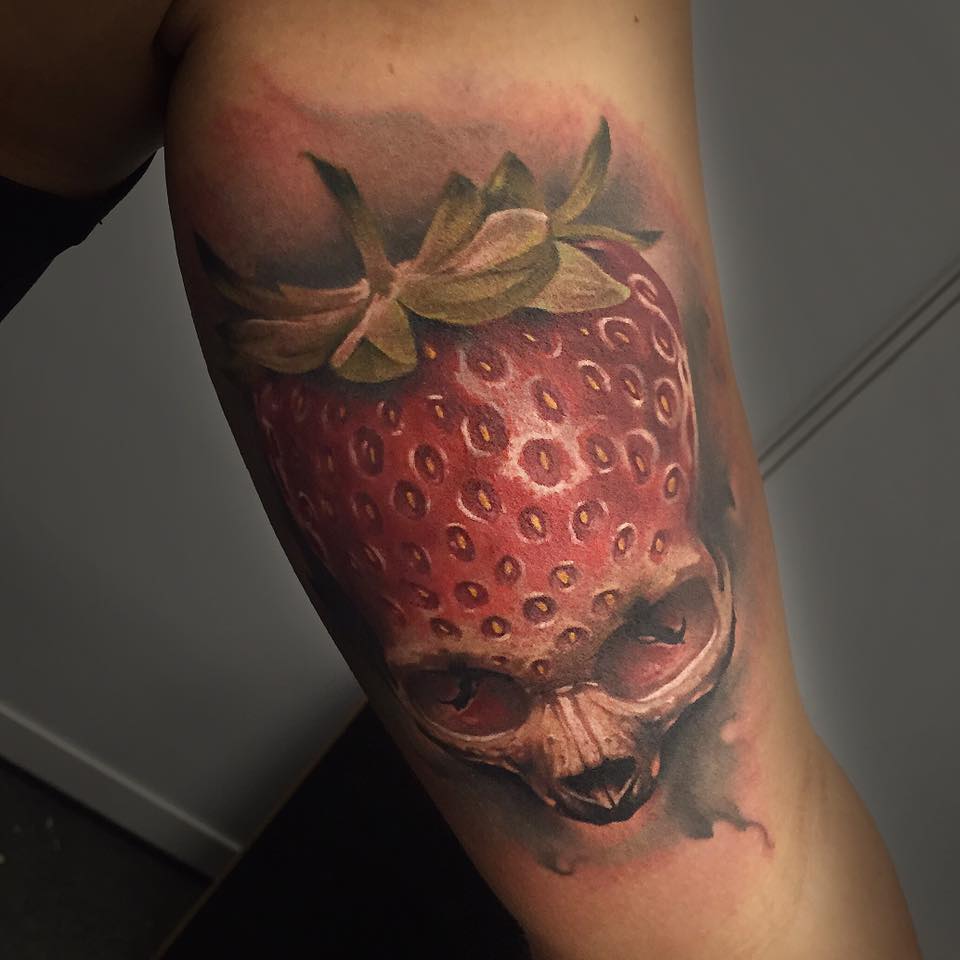 Awesome 3D Strawberry Skull Tattoo On Left Bicep By Benjamin Laukis