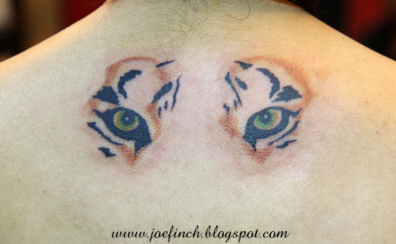 Awesome Tiger Eyes Tattoo On Upper Back by Joefinch