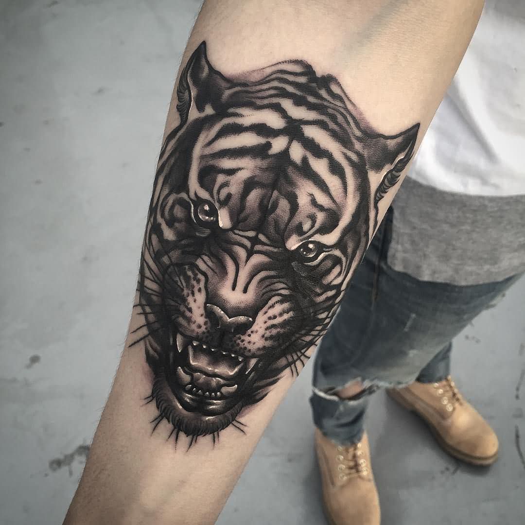 Black And Grey Ink Tiger Face Tattoo On Forearm