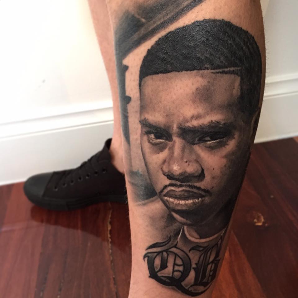 Black And Grey Nas Portrait Tattoo On Left Leg By Benjamin Laukis