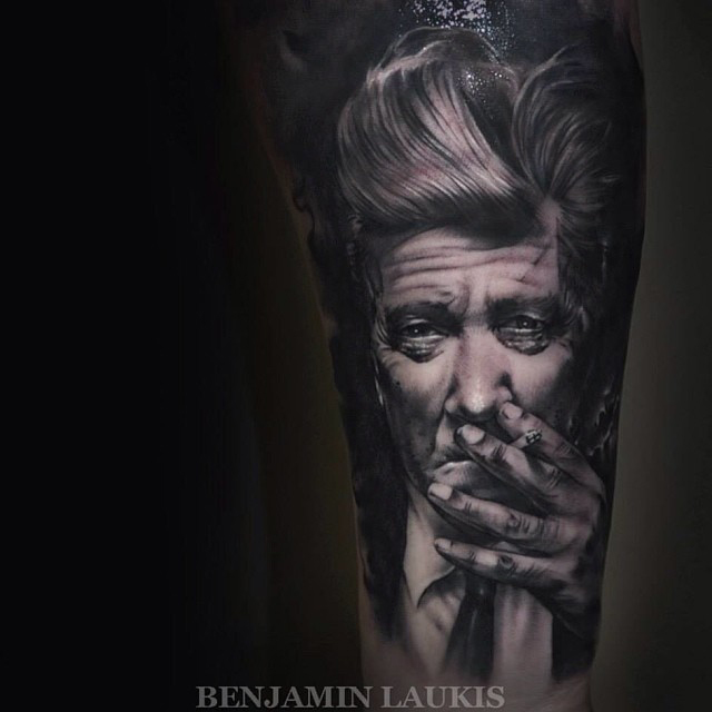 Black And Grey Smoking Man Portrait Tattoo On Left Forearm