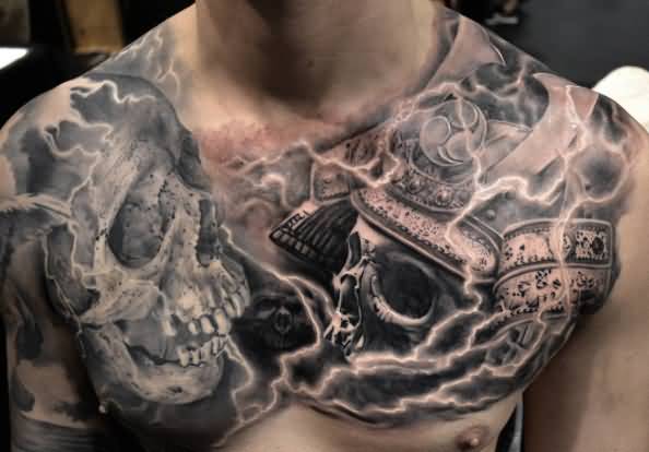 Black And Grey Two Skulls Tattoo On Man Chest