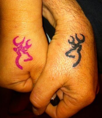 Black And Pink Deer Tattoos On Couple Hands