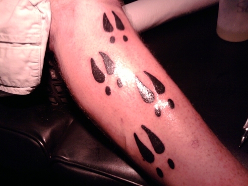 Black Ink Deer Track Tattoo On Leg