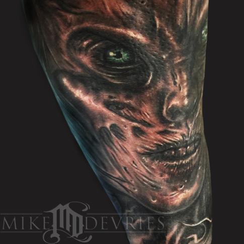 Black Ink Evil Face Tattoo On Half Sleeve By Mike Devries