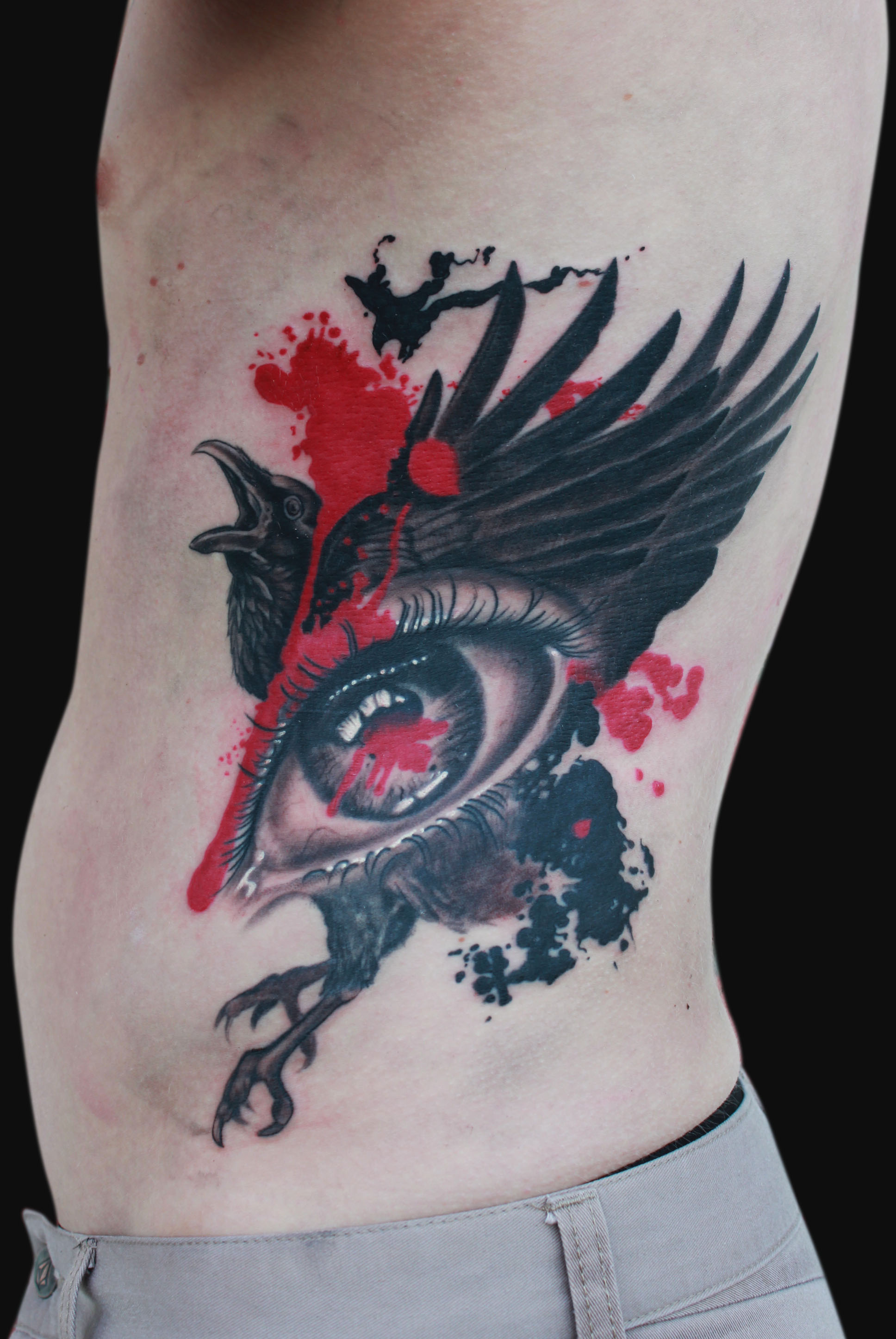 Black Ink Eye With Flying Crow Tattoo On Man Left Side Rib