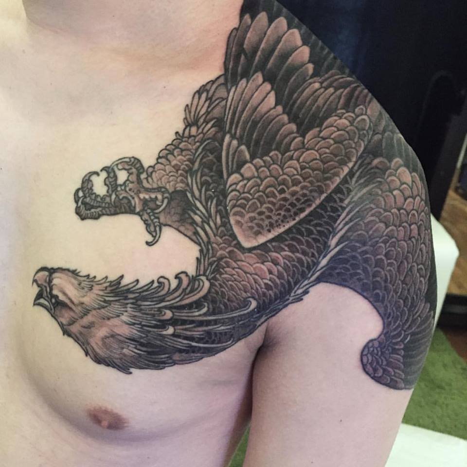 Black Ink Flying Phoenix Tattoo On Man Left Front Shoulder By Elvin
