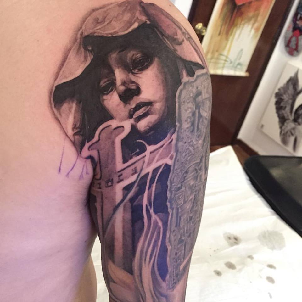 Black Ink Girl Face With Cross Tattoo On Right Half Sleeve By Elvin
