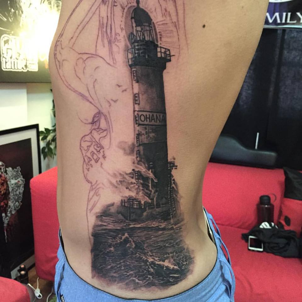 Black Ink Lighthouse Tattoo On Man Left Side Rib